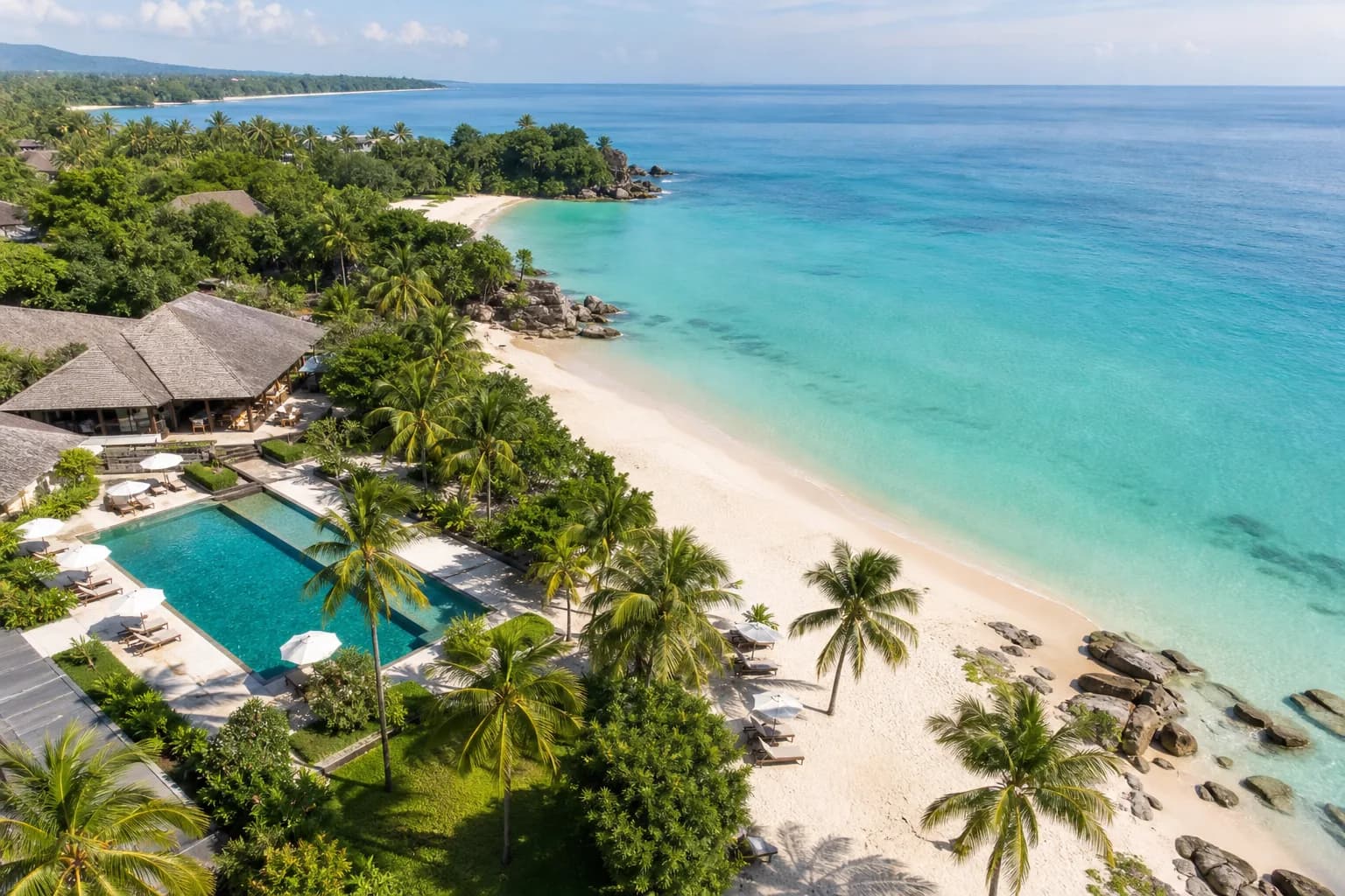 Coastal resort beside a bright beach and calm turquoise water